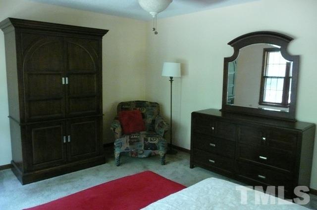 7018 Farmdale Road Raleigh, NC 27610 - Photo 11 of 25 a room with a dresser and a mirror