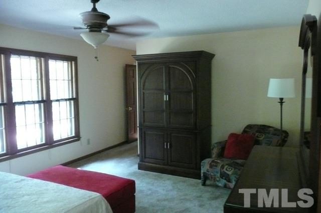 7018 Farmdale Road Raleigh, NC 27610 - Photo 13 of 25 a bedroom with a bed and a window