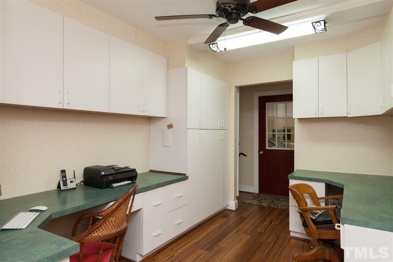 7018 Farmdale Road Raleigh, NC 27610 - Photo 24 of 25 a view of a workspace with furniture and wooden floor