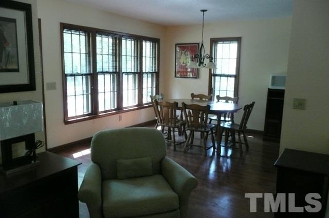 7018 Farmdale Road Raleigh, NC 27610 - Photo 7 of 25 a view of a dining room with furniture window and wooden floor