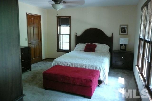 7018 Farmdale Road Raleigh, NC 27610 - Photo 10 of 25 a bedroom with a bed and a walk in closet