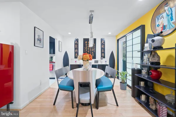 a dining room with furniture and wooden floor