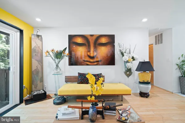 a living room with furniture and a painting on the wall