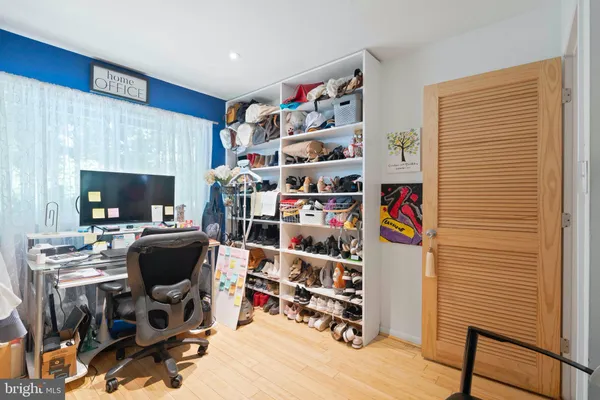 a view of a livingroom with workspace and a window