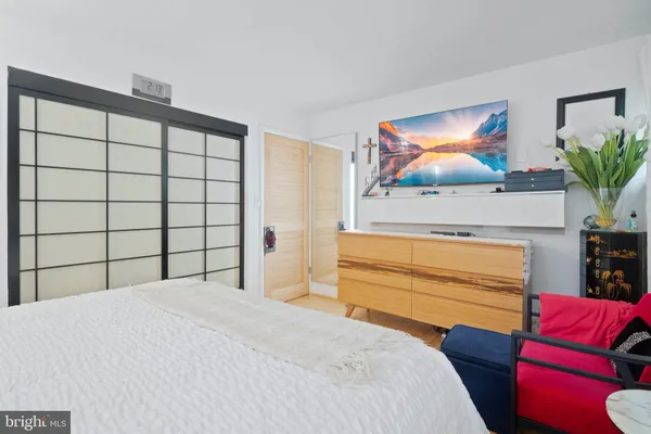 a bedroom with a bed and a flat screen tv