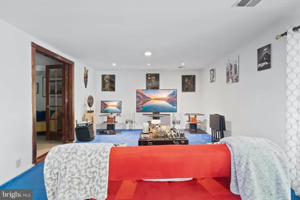 a living room with furniture rug and wooden floor