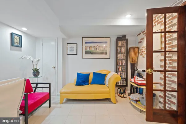 a bedroom with furniture and a large window