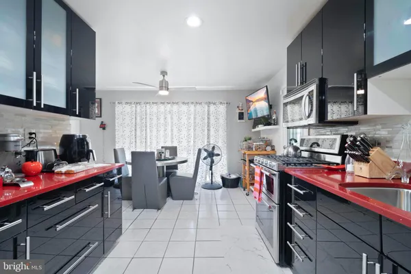 a kitchen filled with stainless steel appliances a sink dishwasher stove and cabinets