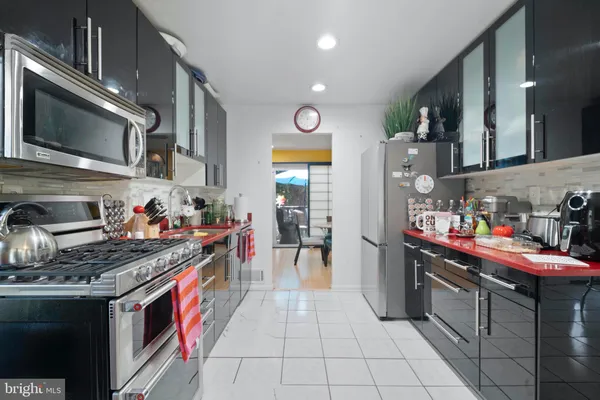 a kitchen with stainless steel appliances granite countertop a stove and cabinets