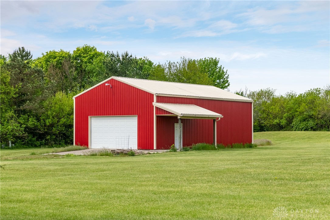 9981 Ridge Acres Lane Englewood, OH 45322 - Photo 46 of 73 This expansive red barn offers generous storage capacity with its durable metal roof and convenient roll-up door.