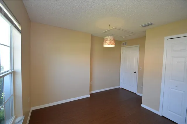 an empty room with windows and entrance