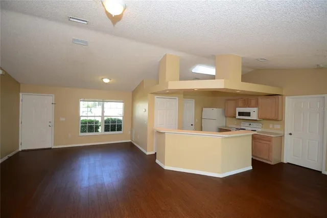 a living room with a sink and a stove top oven