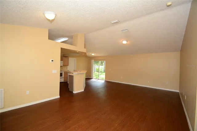 a view of a kitchen with a sink and a refrigerator