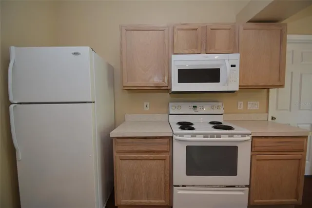 a kitchen with a stove microwave and refrigerator