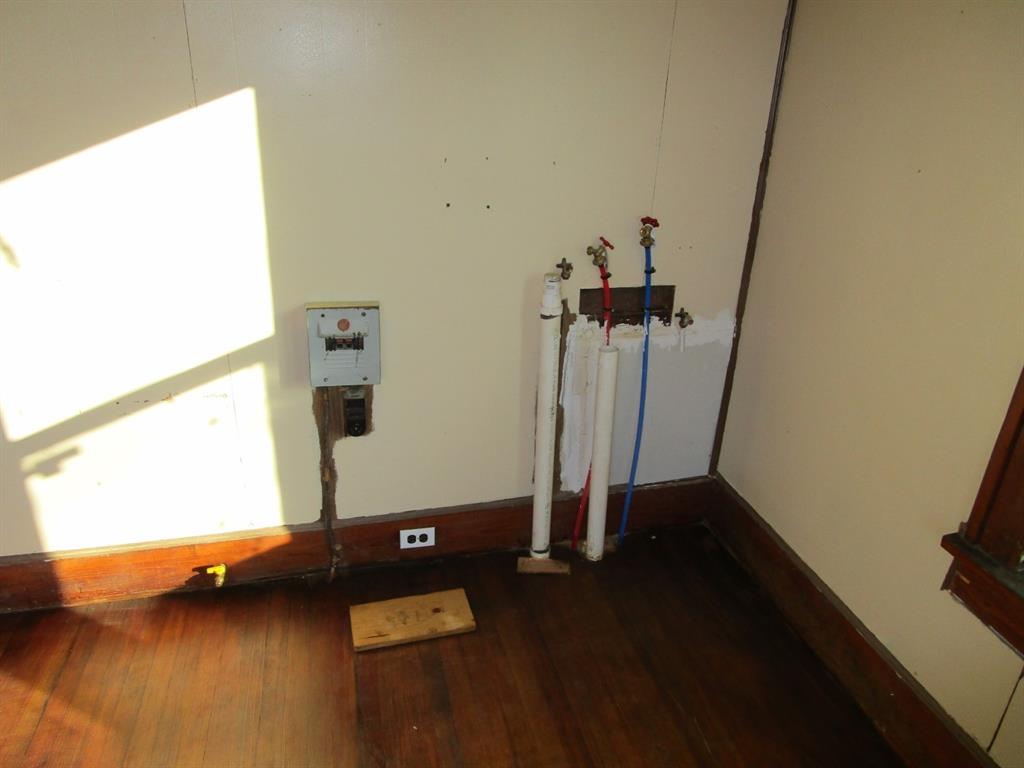 1206 South Main Street Quanah, TX 79252 - Photo 18 of 22 Details featuring baseboards and wood finished floors