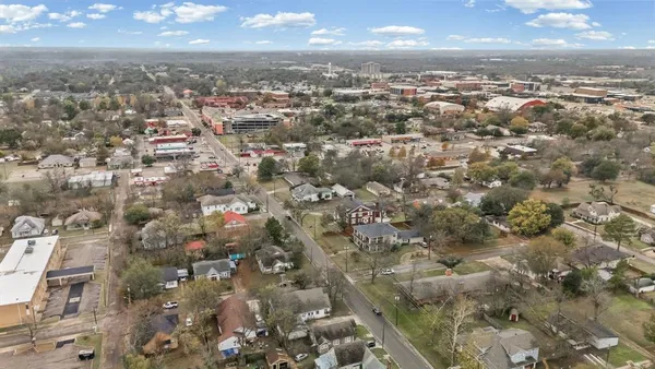 an aerial view of residential building with green space