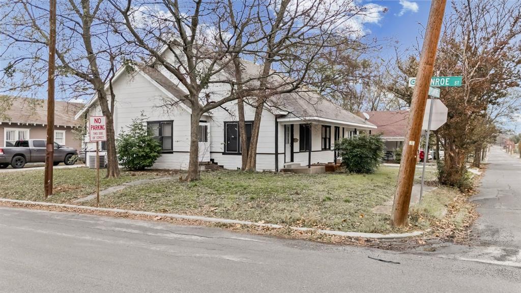 1406 Sycamore Street Commerce, TX 75428 - Photo 4 of 22 a view of a house with a yard covered in snow
