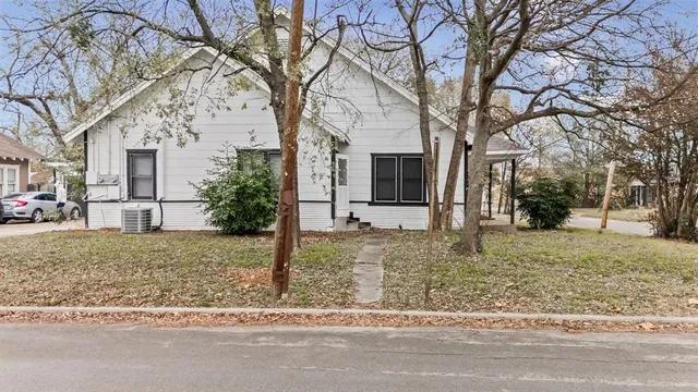 a view of a house with a yard covered in snow