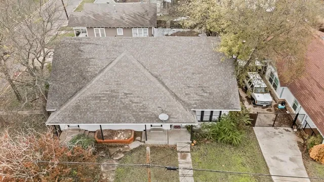 an aerial view of a house with a yard