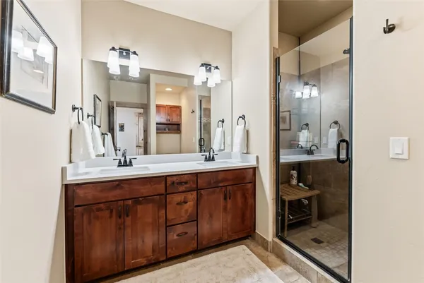 a bathroom with a double vanity sink and a mirror