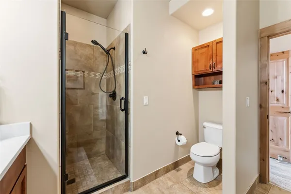 a bathroom with a toilet and a shower
