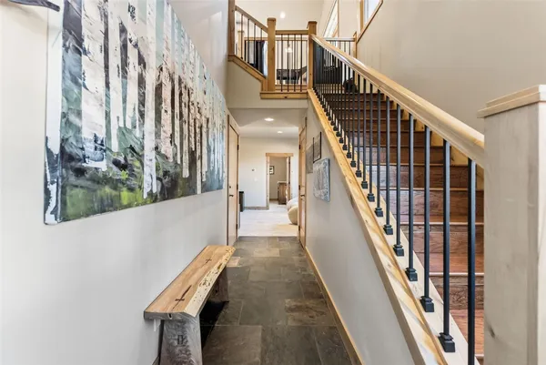 a view of entryway and hall with wooden floor