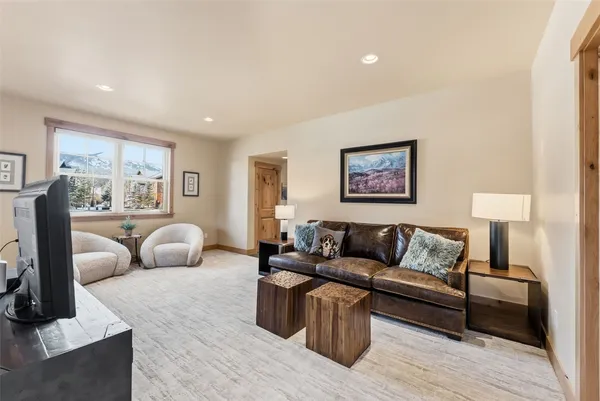 a living room with furniture a lamp and a large window
