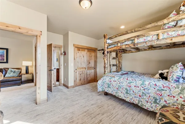 a bedroom with a bed and glass walk in closet