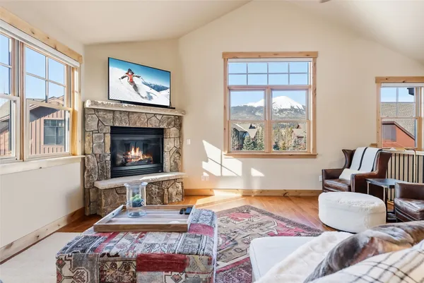 a living room with furniture fireplace and window
