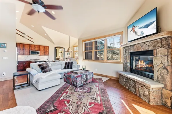 a living room with furniture a flat screen tv and a fireplace