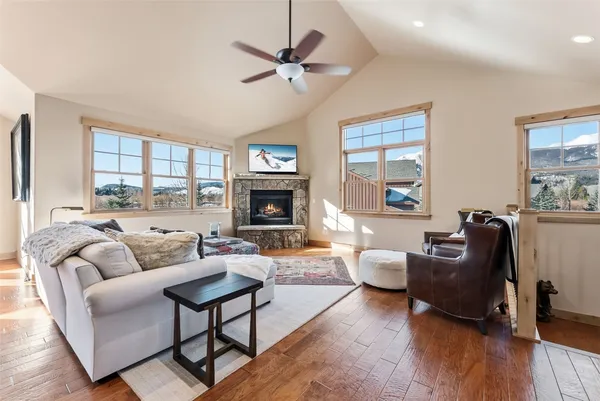 a living room with furniture fireplace and a large window