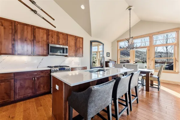 a large kitchen with a table and chairs