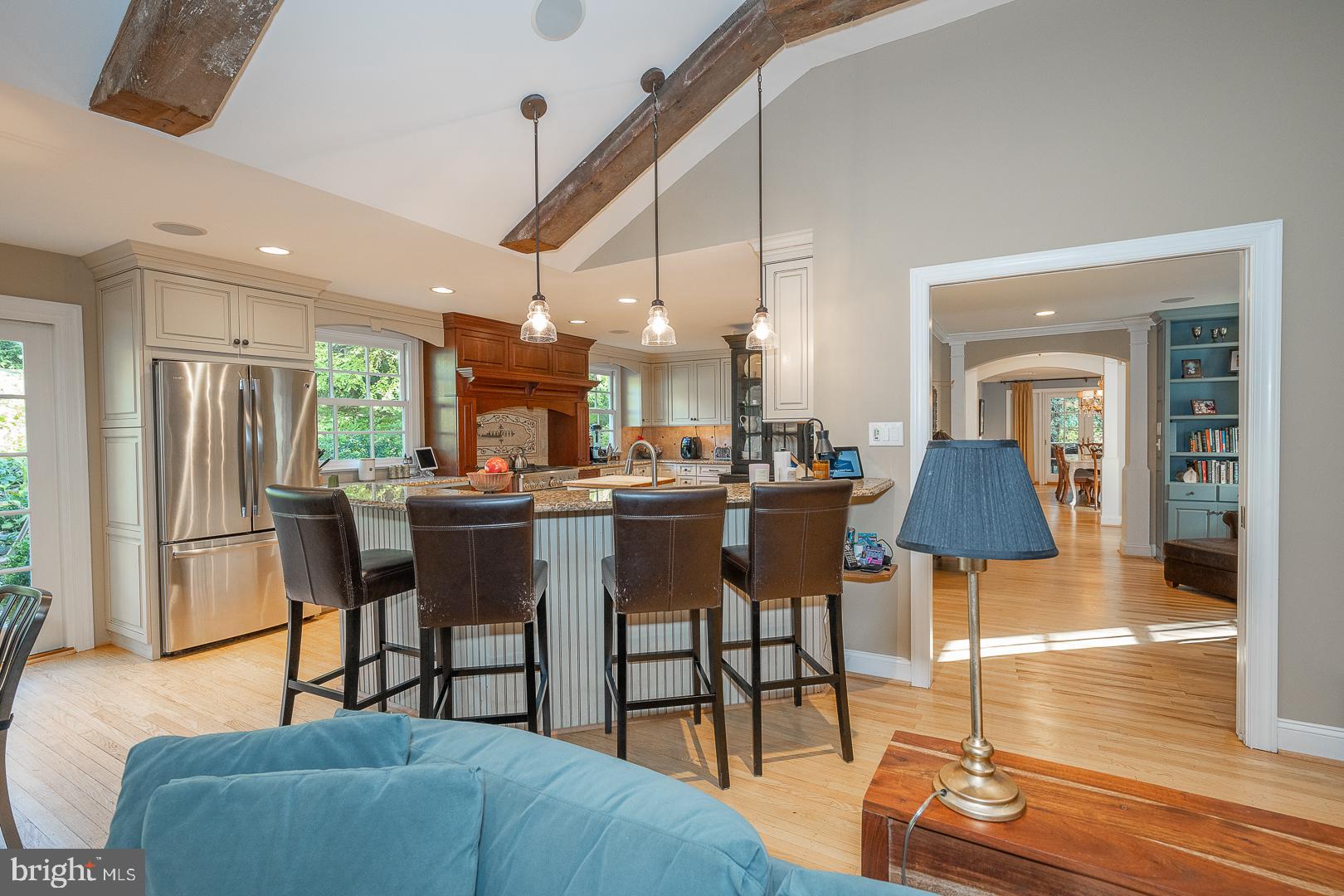 318 Chamounix Road Wayne, PA 19087 - Photo 12 of 55 a kitchen with stainless steel appliances kitchen island granite countertop a table chairs and a living room view