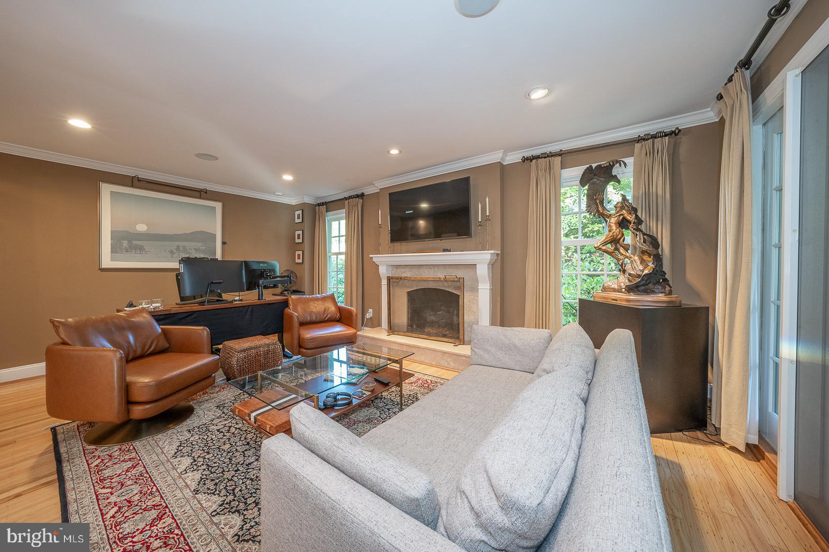 318 Chamounix Road Wayne, PA 19087 - Photo 23 of 55 a living room with furniture a fireplace and a flat screen tv
