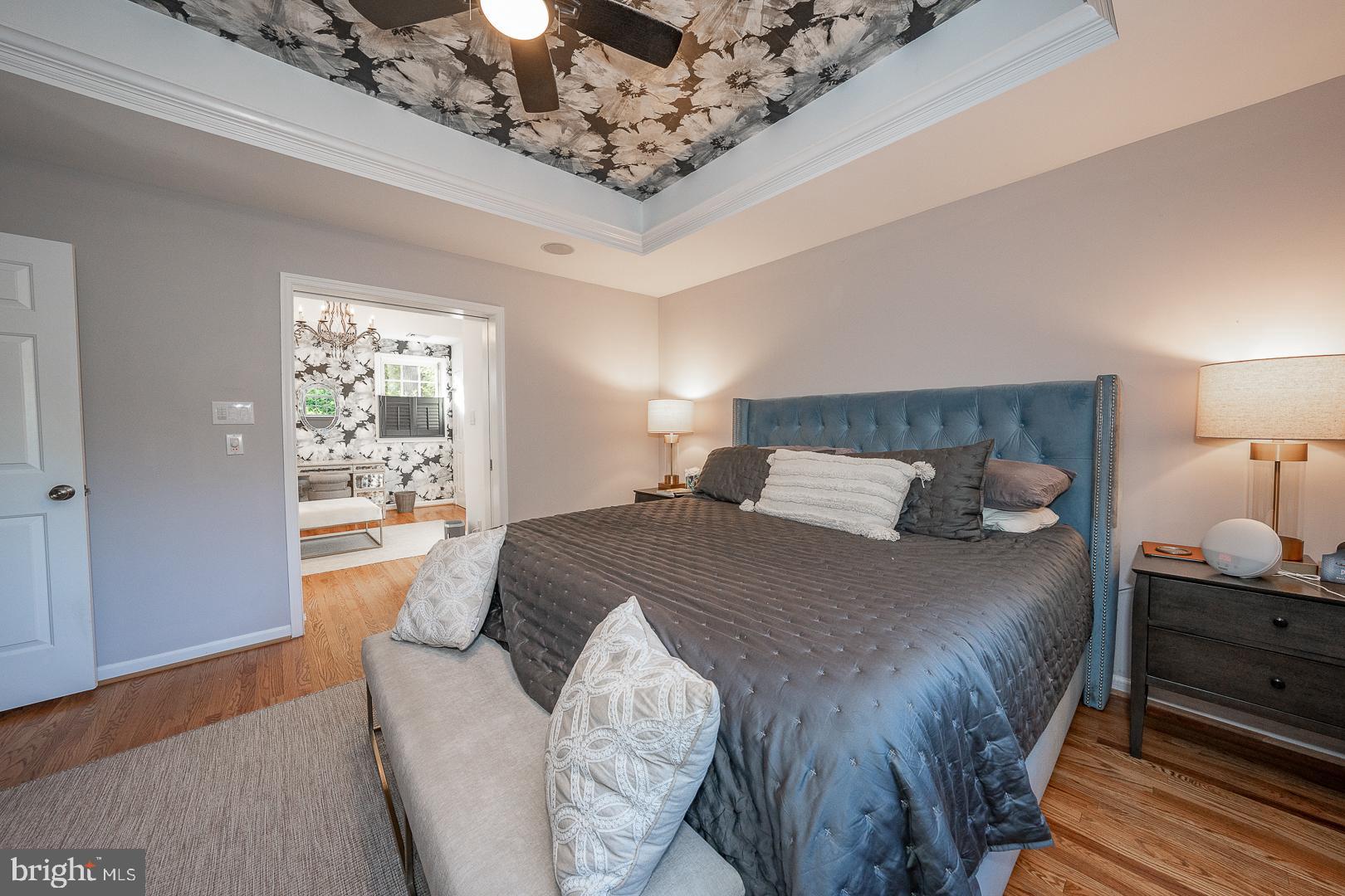 318 Chamounix Road Wayne, PA 19087 - Photo 28 of 55 a bedroom with a large bed and a chandelier