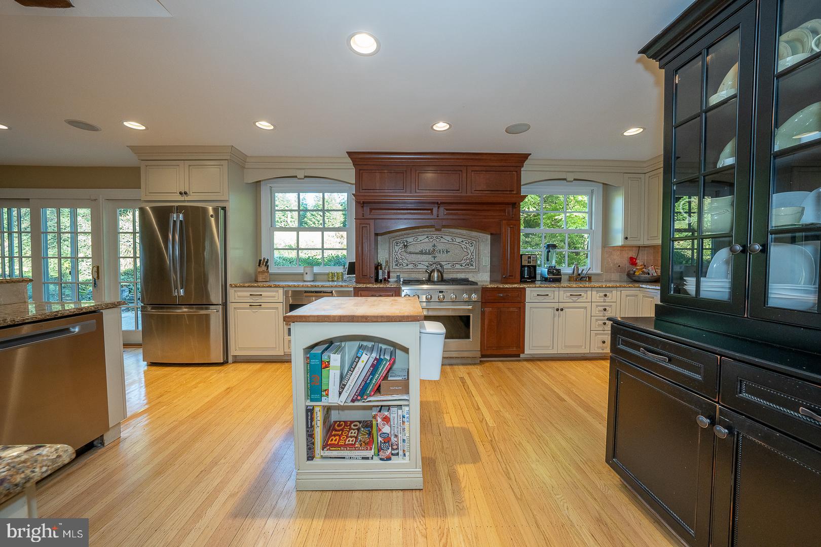 318 Chamounix Road Wayne, PA 19087 - Photo 8 of 55 a kitchen with kitchen island wooden cabinets and refrigerator