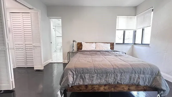 a bed room with a bed and a large mirror