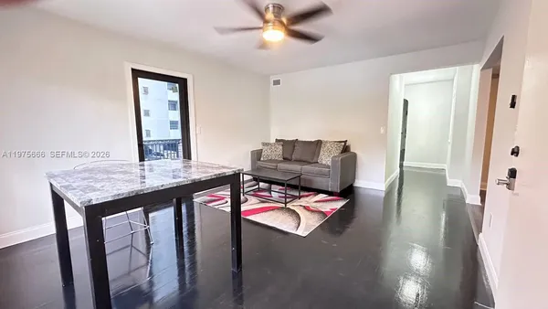 a living room with furniture and wooden floor