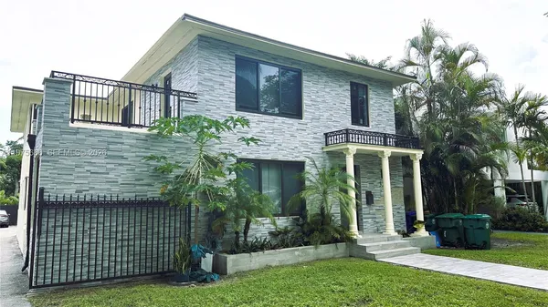 a view of a balcony with a floor to ceiling window and wooden fence