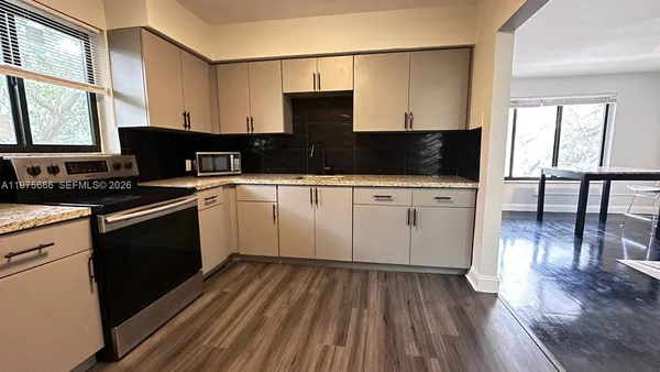 a kitchen with a sink stove and cabinets