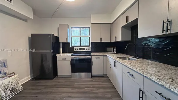 a kitchen with a sink stove and refrigerator