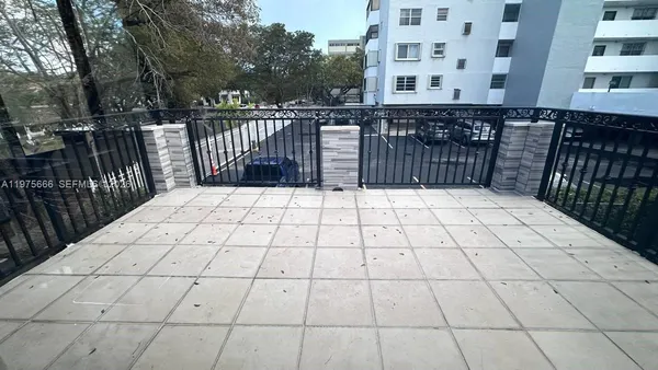 a view of a patio with a table and chairs