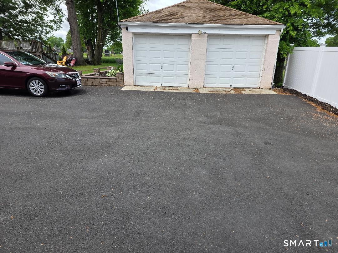 103 Windsor Street Enfield, CT 06082 - Photo 6 of 22 a view of garage yard and garage