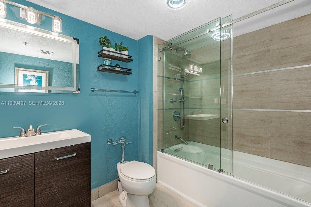 1500 Bay Road, Unit 128S Miami Beach, FL 33139 - Photo 11 of 27 a bathroom with a sink toilet and shower