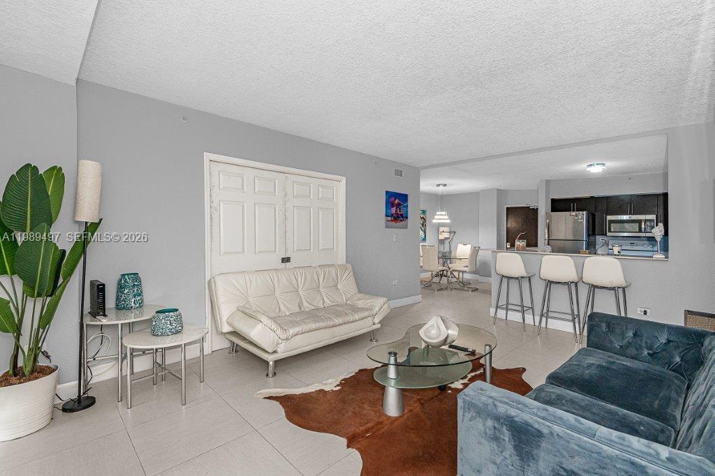 1500 Bay Road, Unit 128S Miami Beach, FL 33139 - Photo 15 of 27 a living room with furniture and a couch