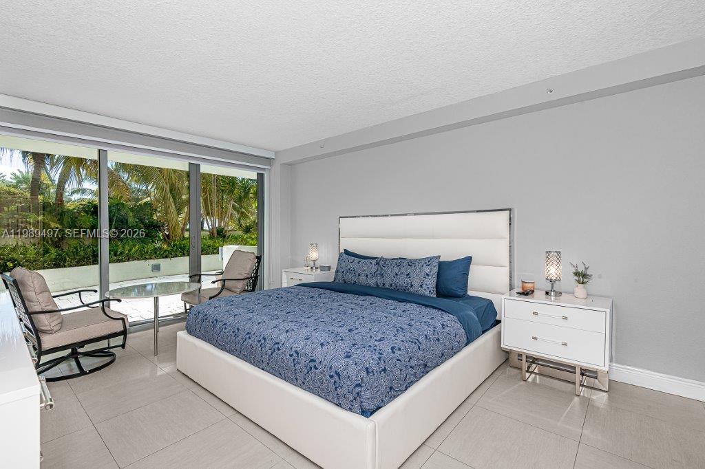 1500 Bay Road, Unit 128S Miami Beach, FL 33139 - Photo 8 of 27 a living room with a bed and large window