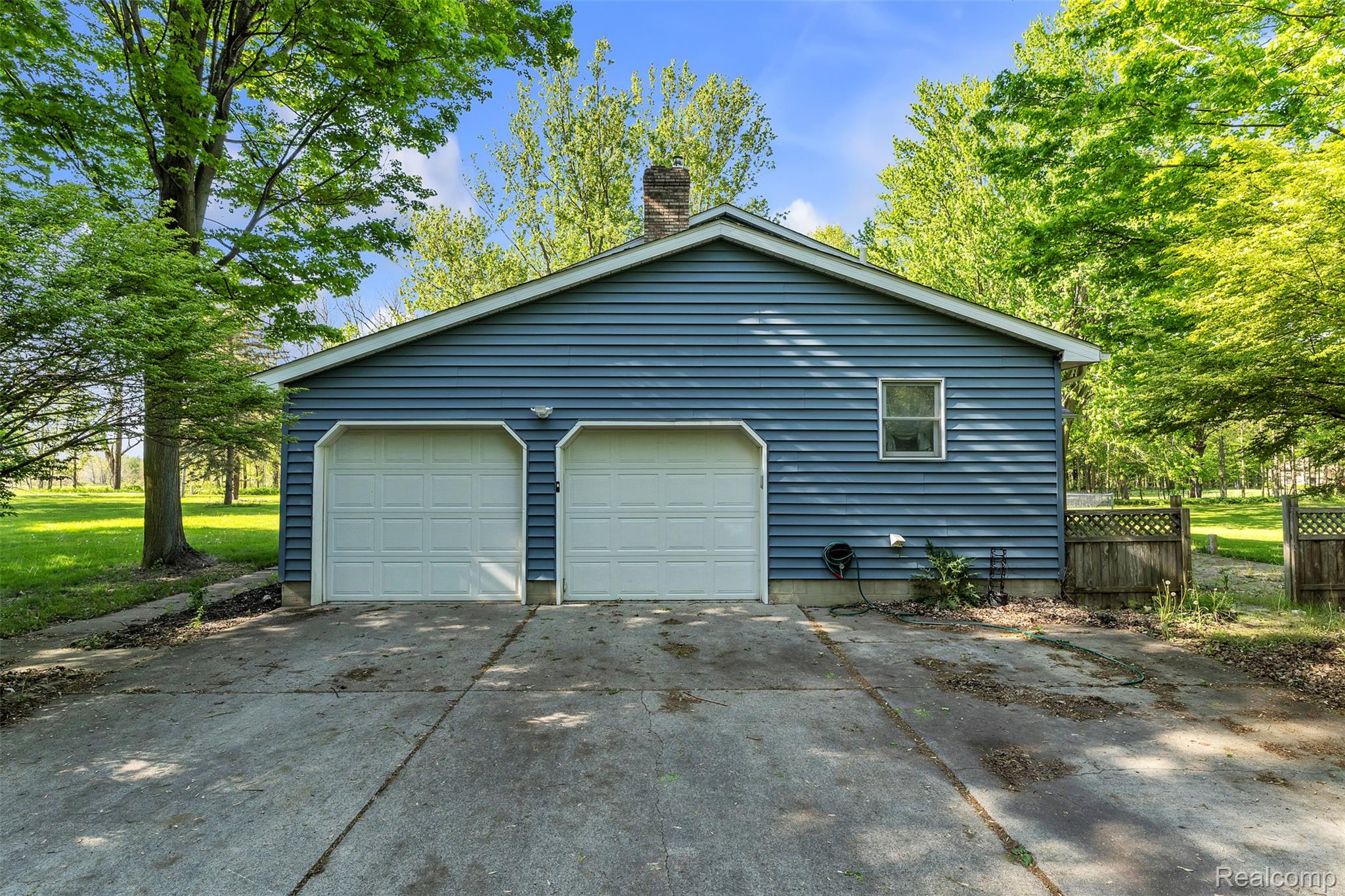 1345 Ives Road Mason, MI 48854 - Photo 57 of 92 View of side of property with a chimney and a garage
