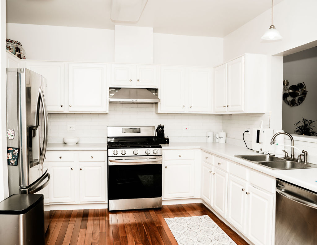 3389 Ravinia Circle Aurora, IL 60504 - Photo 11 of 39 a kitchen with stainless steel appliances a stove a sink and a refrigerator