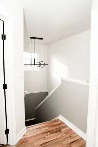 a view of a bedroom with wooden floor and a window