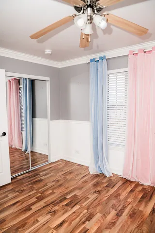 a view of a bedroom window and wooden floor
